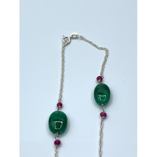 155 - An oval emerald necklace with rubies and a 925 sterling silver enamel ring