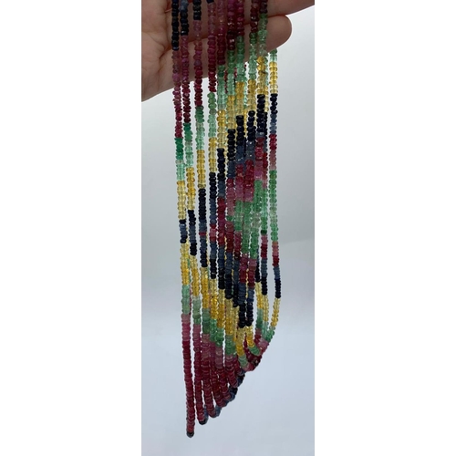 47 - A beautiful, nine rows, of ruby, emerald and sapphire faceted beads,necklace. Approximately 1900 pre... 