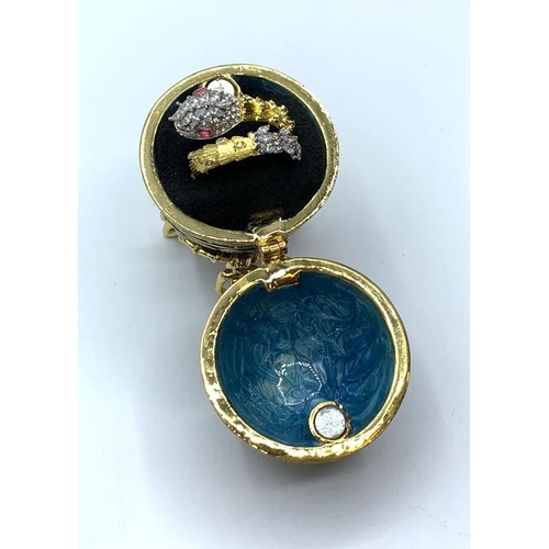 56 - A yellow and white metal ring with gems in the form of a highly ornate. snake presented in “Faberge”... 