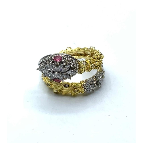 56 - A yellow and white metal ring with gems in the form of a highly ornate. snake presented in “Faberge”... 