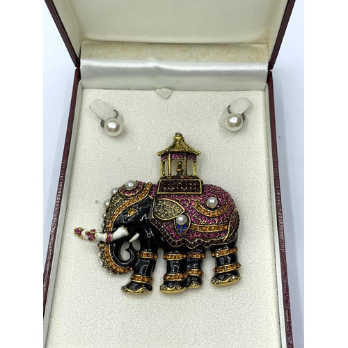 63 - A large, enamel and gems, brooch depicting an Indian ceremonial Elephant, together with a pair of ea... 