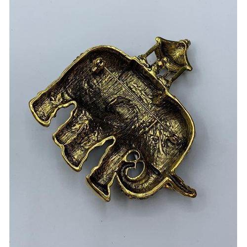 63 - A large, enamel and gems, brooch depicting an Indian ceremonial Elephant, together with a pair of ea... 