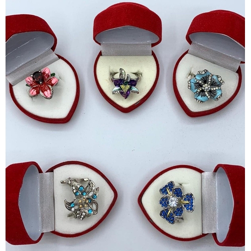 68 - Five silver (stamped “925”) floral rings with enamel and gems in heart shaped red velvet presentatio... 