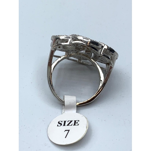 72 - A brand new silver (stamped “925”) and cubic zirconia dress ring. Size: N, weight: 8g.