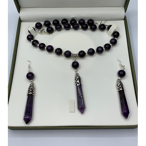 80 - A boxed  amethyst necklace and earrings set. White metal clasp stamped “925”. Necklace length (max):... 