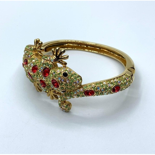 90 - Two bracelets, one yellow metal, representing a Gecko with green and red crystals and the other one,... 