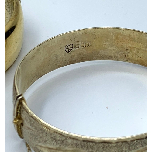 394 - Rolled gold bangle & a silver + gold bangle, weight 68g