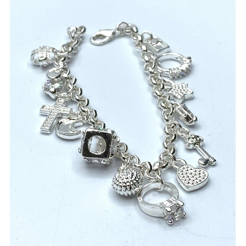 415 - Silver charm bracelet with 12 charms, weight 20g & length 18cms