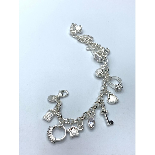 415 - Silver charm bracelet with 12 charms, weight 20g & length 18cms