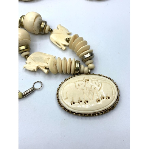 254 - 2 Vintage Bone Necklaces One Beaded One with Elephants Pendant and One Carved Elephant.