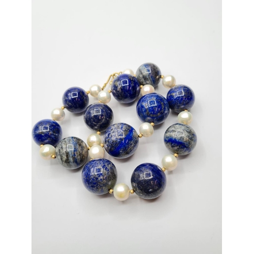 508 - Large lapis lazuli and pearl necklace designed and owned by 'Cher'. Weight 3.8g and length 25cms