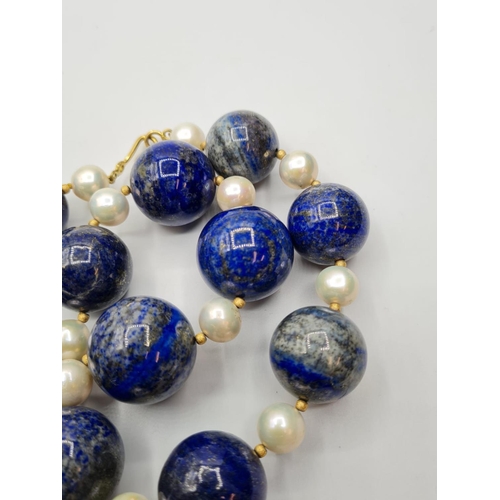 508 - Large lapis lazuli and pearl necklace designed and owned by 'Cher'. Weight 3.8g and length 25cms