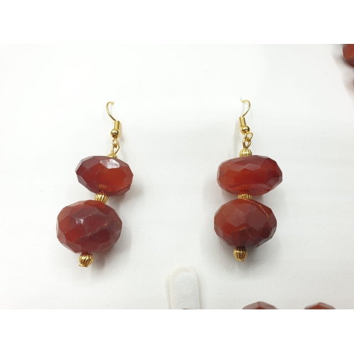 560 - An impressive faceted carnelian necklace and earrings set with gold filled spacer beads in a present... 