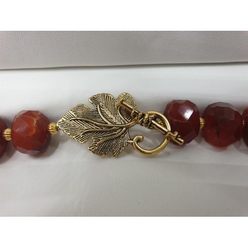 560 - An impressive faceted carnelian necklace and earrings set with gold filled spacer beads in a present... 