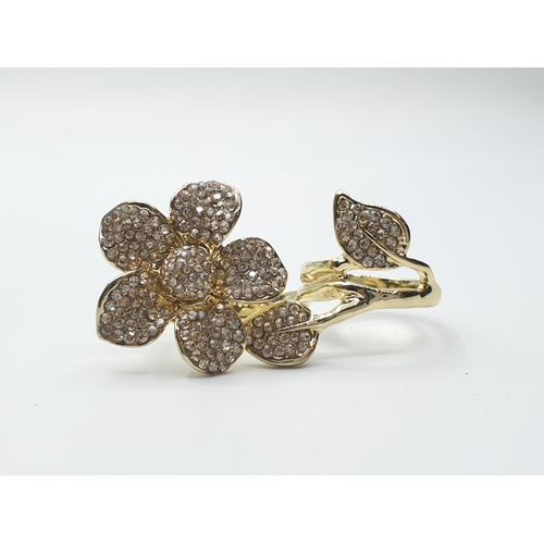 566 - An unusual, silver (stamped “925”) and 18ct gold filled, two finger ring with cubic zirconia.