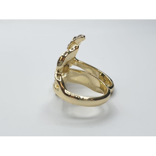 566 - An unusual, silver (stamped “925”) and 18ct gold filled, two finger ring with cubic zirconia.