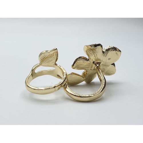 566 - An unusual, silver (stamped “925”) and 18ct gold filled, two finger ring with cubic zirconia.