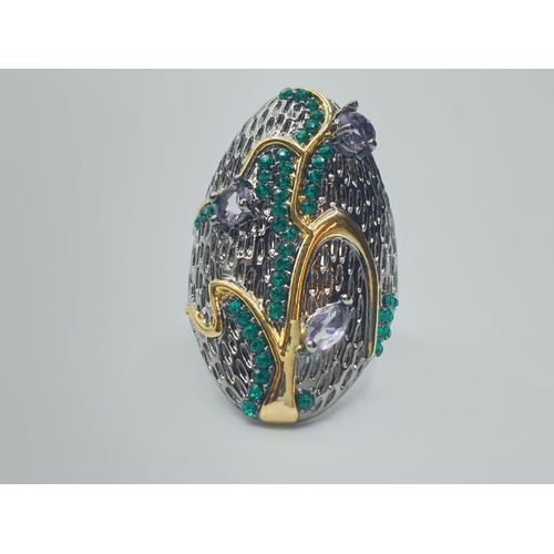 567 - A Scandinavian designer’s silver (stamped “925”) ring with 18ct gold accents and gems. Ring size: N