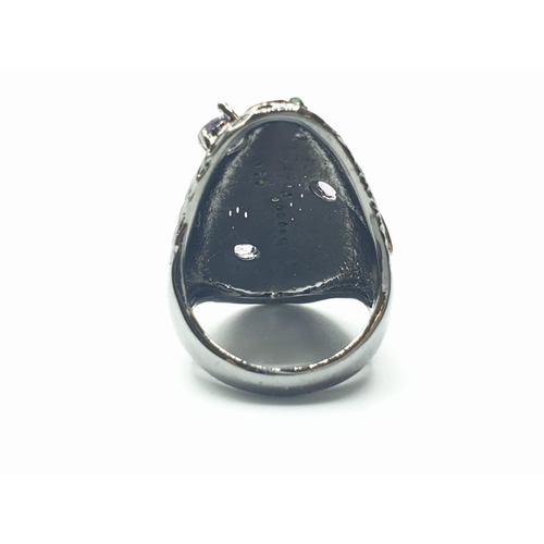 567 - A Scandinavian designer’s silver (stamped “925”) ring with 18ct gold accents and gems. Ring size: N