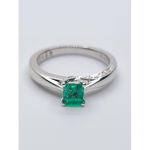 37 - 18ct white gold emerald single stone ring with diamonds set on side of setting, weight 3.3g with 0.4... 