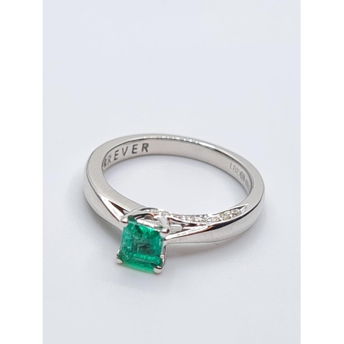 37 - 18ct white gold emerald single stone ring with diamonds set on side of setting, weight 3.3g with 0.4... 