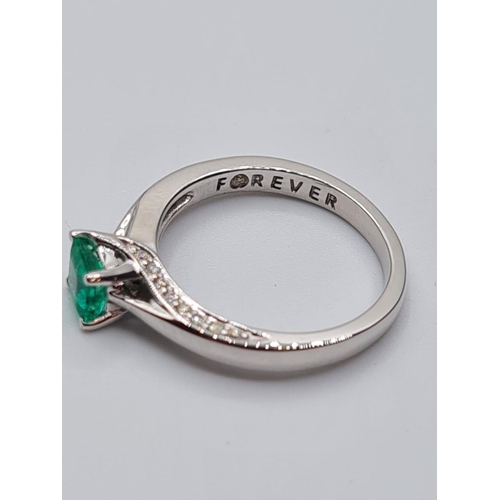 37 - 18ct white gold emerald single stone ring with diamonds set on side of setting, weight 3.3g with 0.4... 