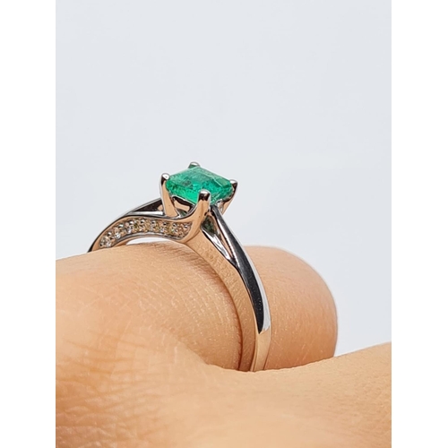 37 - 18ct white gold emerald single stone ring with diamonds set on side of setting, weight 3.3g with 0.4... 