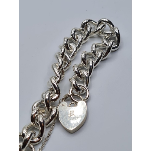 84 - Heavy sterling silver bracelet with heart padlock. weight 74g