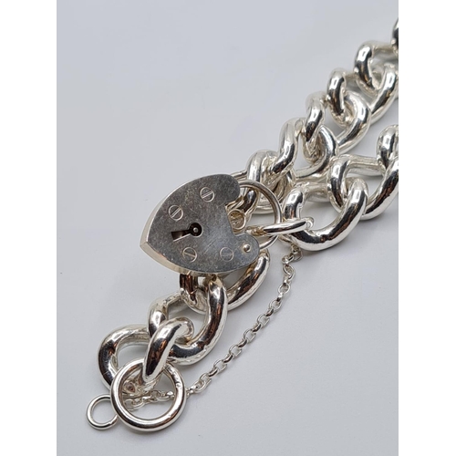 84 - Heavy sterling silver bracelet with heart padlock. weight 74g