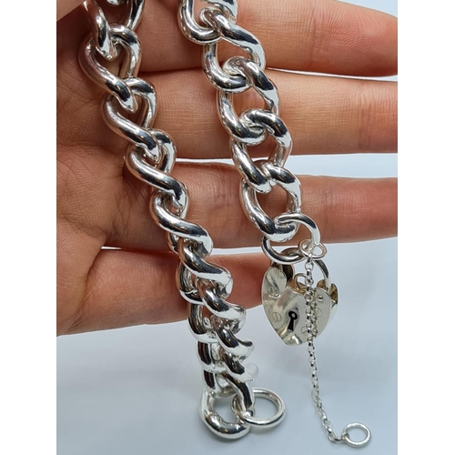 84 - Heavy sterling silver bracelet with heart padlock. weight 74g