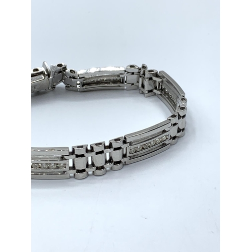 65 - 18ct white gold bracelet with inset diamond, 32.9g weight and 27cm