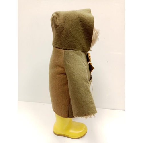 571 - An original 1970s Paddington bear in green felt coat, label and yellow Dunlop wellington boots. Stit... 