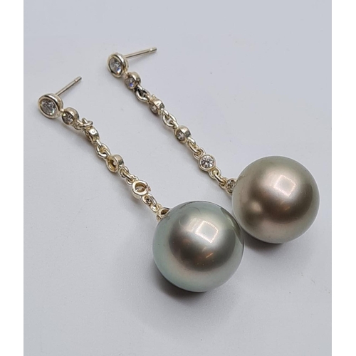 577 - 18ct white gold drop pearl earrings with 6 small diamonds on drop chain, weight 10g