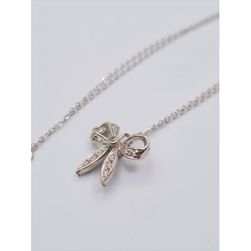 592 - 18ct diamond bow pendant on 40cm necklace, weight 1.8g