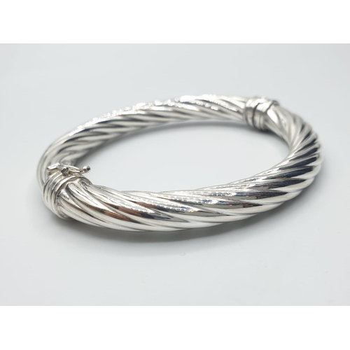 386 - sterling silver twisted bangle, weight 20g and 7.5cm wide