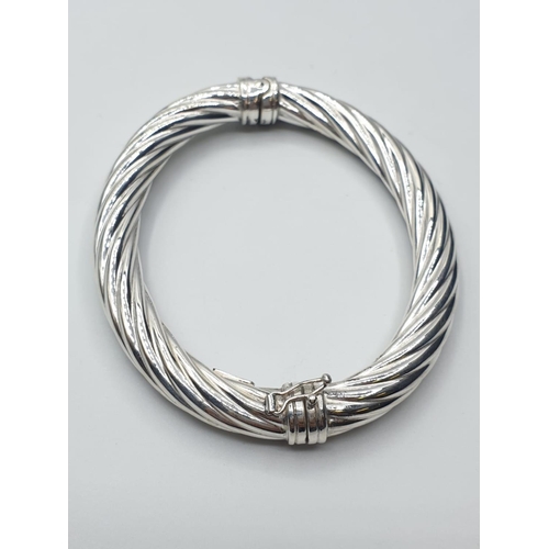 386 - sterling silver twisted bangle, weight 20g and 7.5cm wide