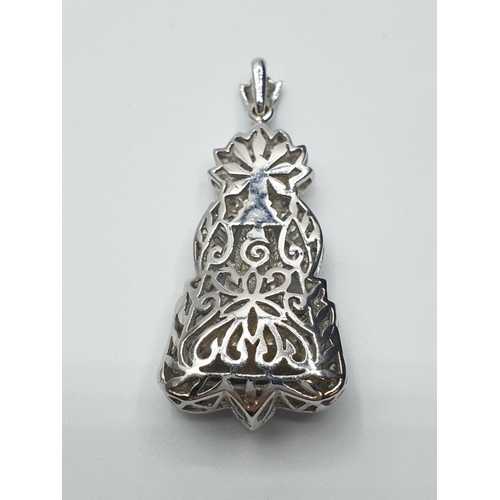 83 - 18ct white gold and diamond Buddha pendant. weight 18.1g and 4cm drop