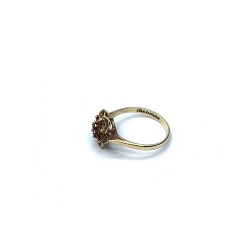 619 - Stone set 9ct gold ring having a mount in pierced flower form with a seven stone garnet arrangement.... 