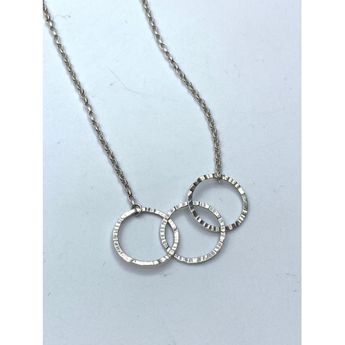 635 - Silver chain and pendant. Pendant consisting three silver hoops connected in 'Olympic' style. London... 