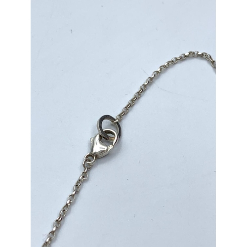 635 - Silver chain and pendant. Pendant consisting three silver hoops connected in 'Olympic' style. London... 