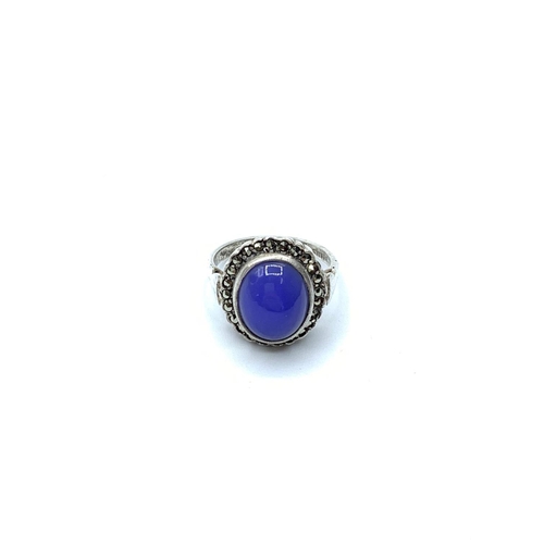 645 - Stone set silver ring having royal blue oval cabochon to mount set in a surround of silver marcasite... 