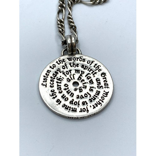 655 - Silver pendant and chain pendant in circular disc form having a Doreen Valientes poem to both sides.... 