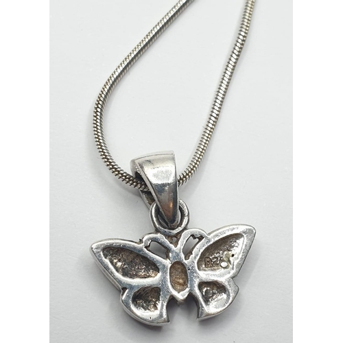 545 - Silver butterfly pendant on a silver chain. Gift boxed. Delicate butterfly having pink and green spa... 