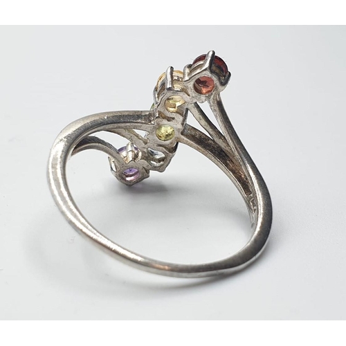 558 - Stone set silver ring having five coloured gemstones in serpentine mount. Stones included are Garnet... 