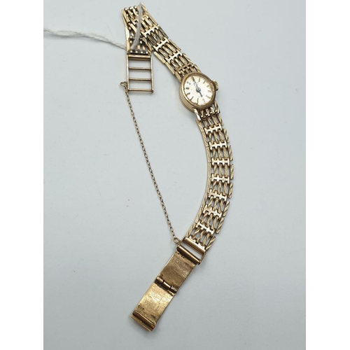 664 - A vintage ladies Rotary 9ct gold wristwatch with gold gate bracelet strap and security chain. 16.4g ... 