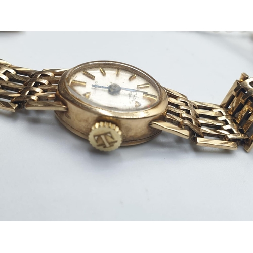 664 - A vintage ladies Rotary 9ct gold wristwatch with gold gate bracelet strap and security chain. 16.4g ... 