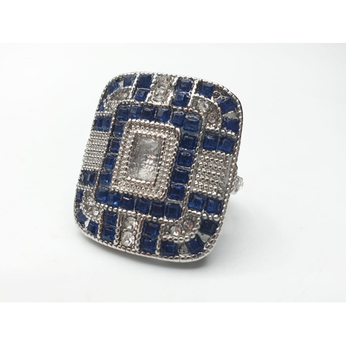 150 - An Art Deco, silver (stamped 925) ring, of large proportions, with blue and white sapphires. Present... 