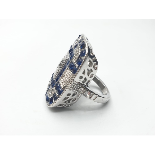 150 - An Art Deco, silver (stamped 925) ring, of large proportions, with blue and white sapphires. Present... 