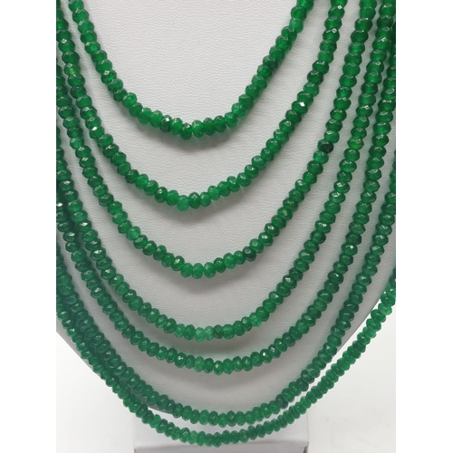 64 - A seven row faceted emerald necklace. Emerald is heat treated and colour enhanced. Length: 43 -64cm.... 