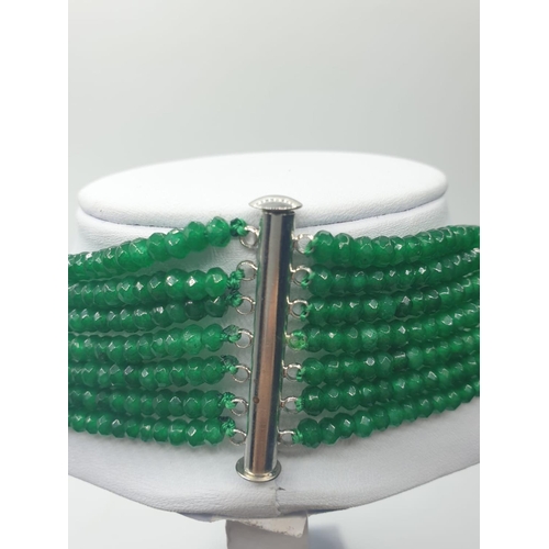 64 - A seven row faceted emerald necklace. Emerald is heat treated and colour enhanced. Length: 43 -64cm.... 